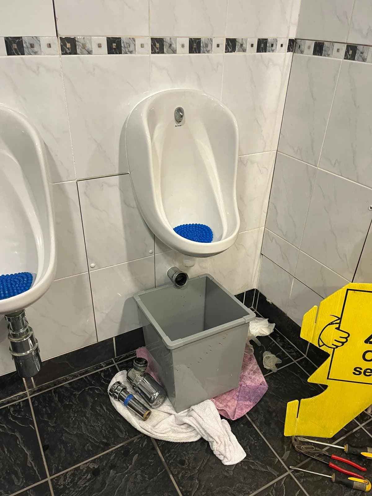Commercial urinal before plumbing repair