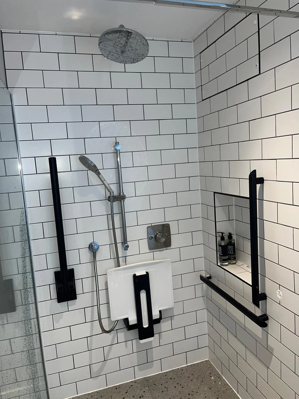 Accessible shower area with controls and support fittings completed