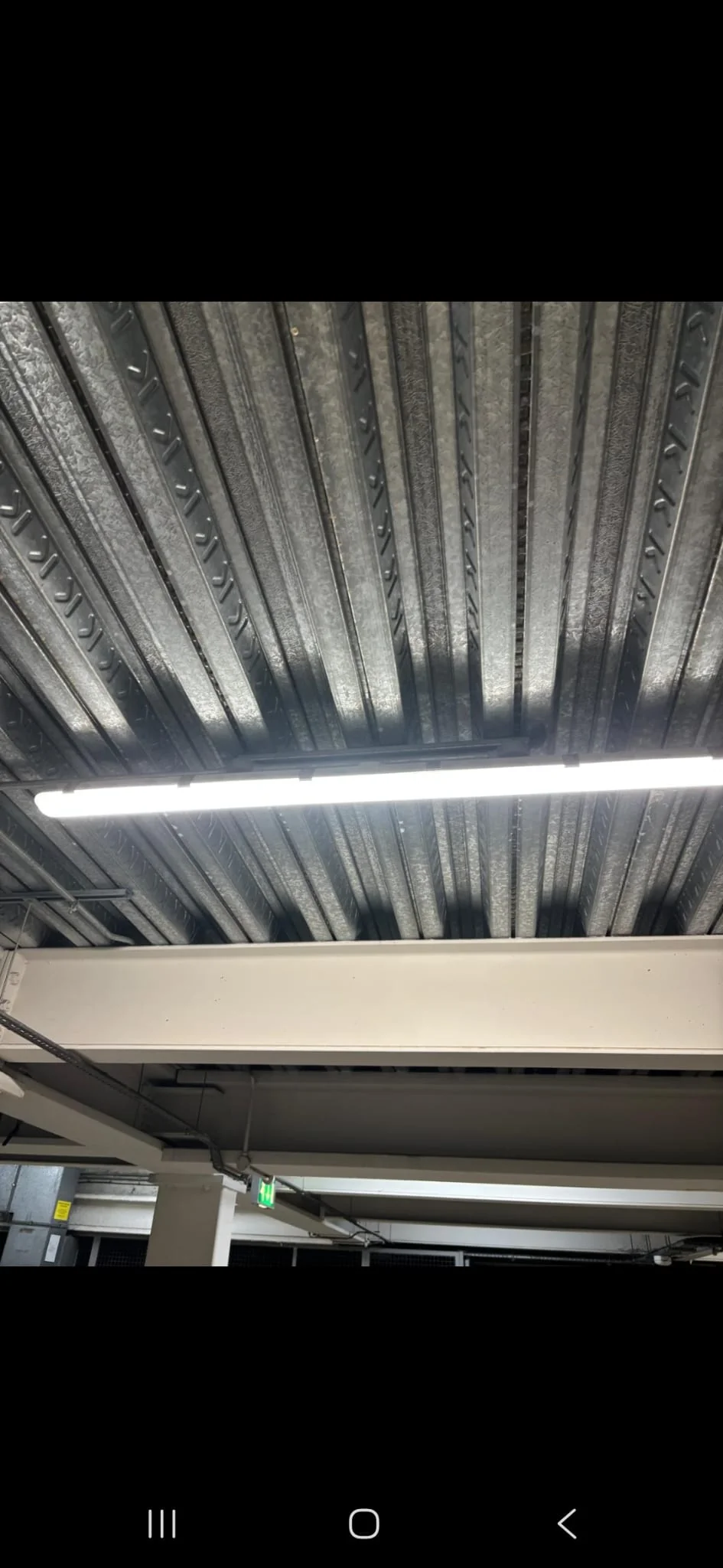 Commercial ceiling lighting inspected during maintenance