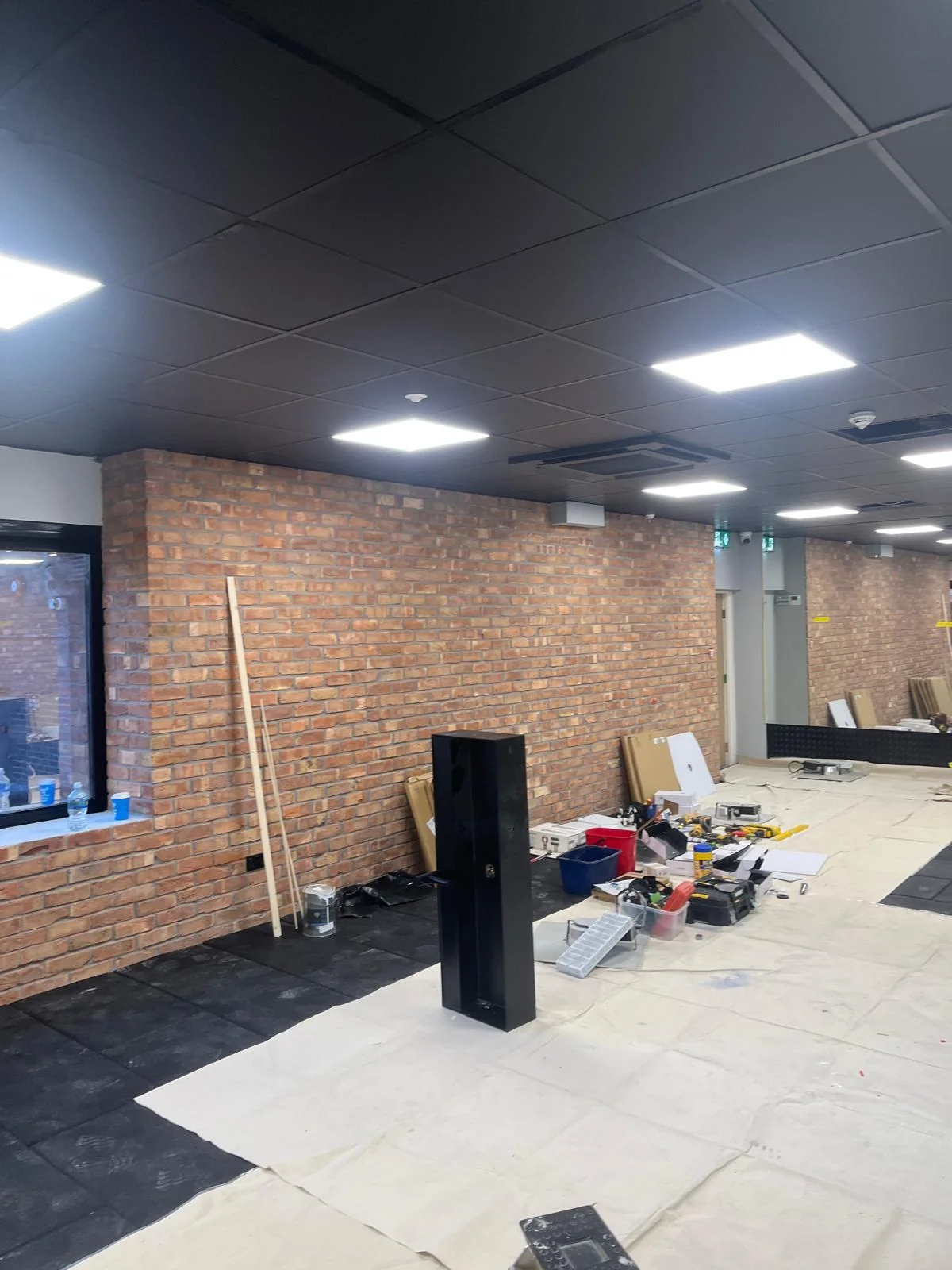 Brick-walled room before refurbishment works began