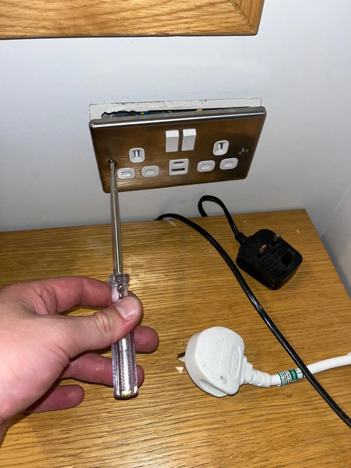 Second socket wiring exposed during electrical repair