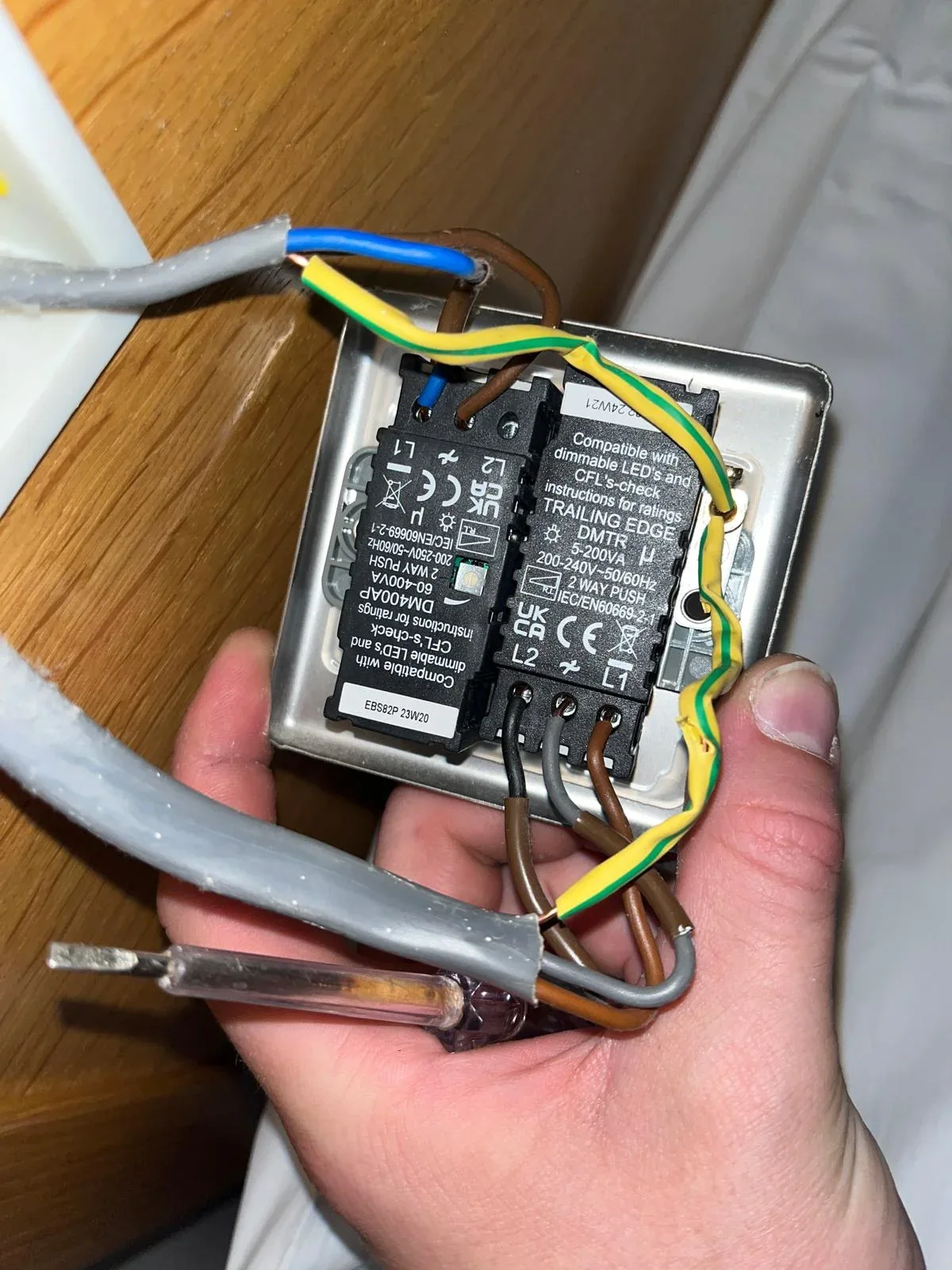 Socket wiring exposed during electrical inspection