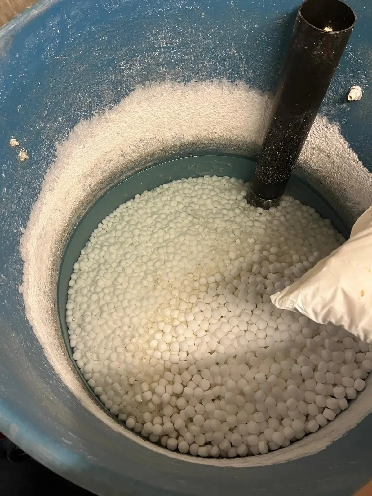 Water softener salt refill during routine maintenance