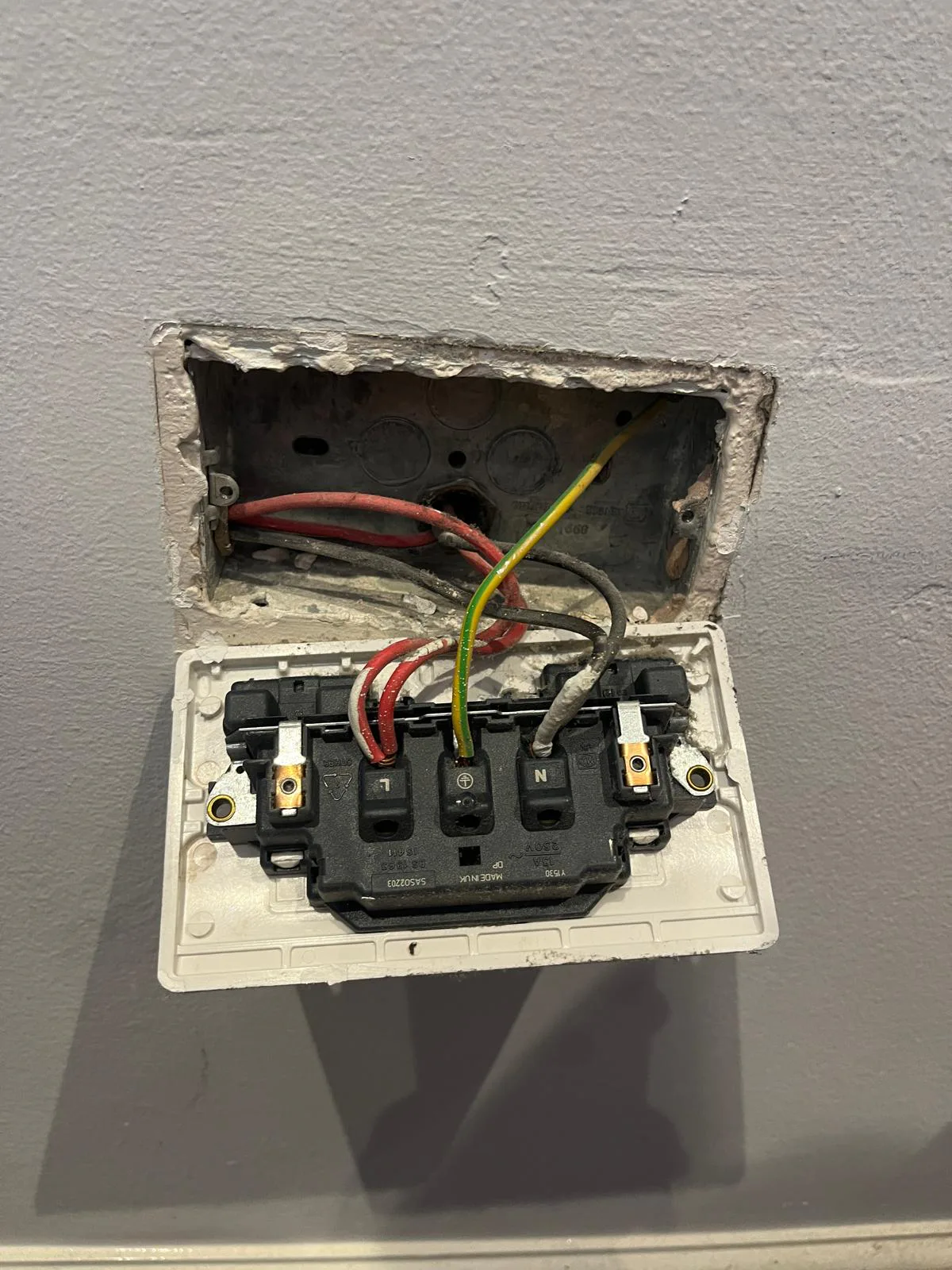 Electrical Check During Socket Replacement Electrician checking wiring during double socket replacement